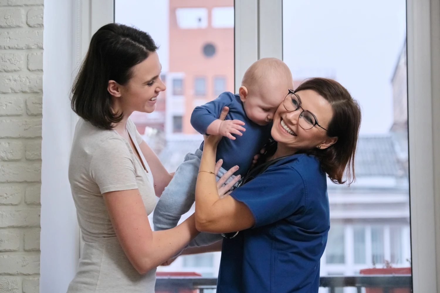 Health visitor holding a baby