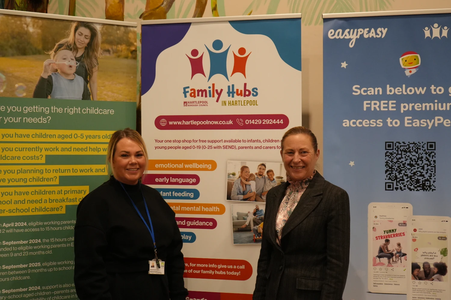 Family Hub team members stood in front of a roller banner