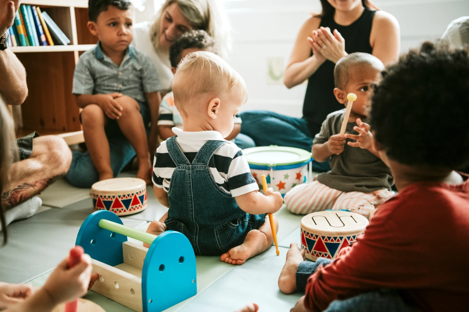 Infant playing with toy musical instruments